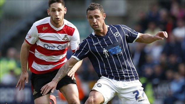 Millwall's Scott McDonald (right) takes the ball past Doncaster"s Dean Furman (left)