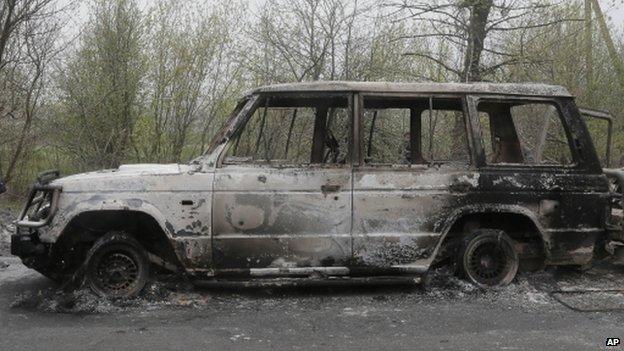 Burnt out cars after a night fight at the check point which was under the control of pro-Russian activists in the village of Bulbasika near Slovyansk, Ukraine, Sunday, April 20, 2014.