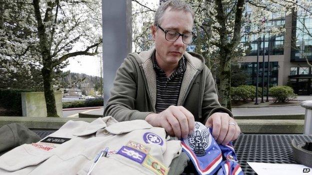 Geoff McGrath displays his Boy Scout scoutmaster uniform shirt and other scout items for the Seattle troop he led, in Bellevue, Washington 1 April 2014