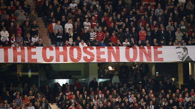 Manchester United fans at Old Trafford next to the David Moyes 'The Chosen One' banner