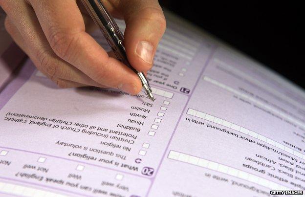 Man filling in section of form entitled: "What is your religion?"