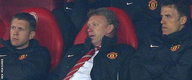 Moyes slumps in his seat in the dugout during United's first leg Champions League defeat to Olympiakos