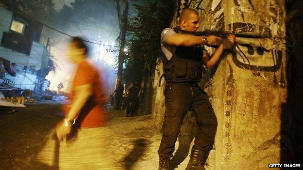 Brazilian police patrol following shootings in the pacified Pavao-Pavaozinho community, just blocks from Copacabana Beach on 22 April, 201