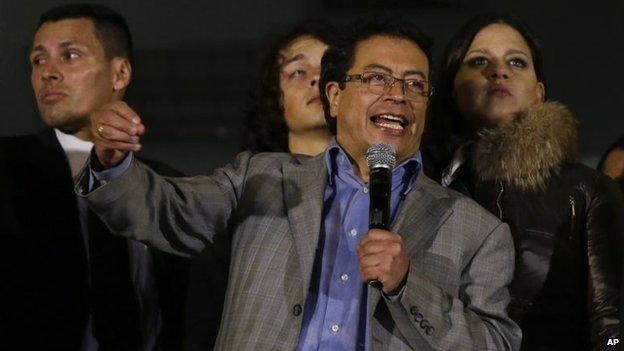 In this March 19, 2014, file photo, Bogota Mayor Gustavo Petro speaks to supporters from a balcony of the city hall in Bogota, Colombia.