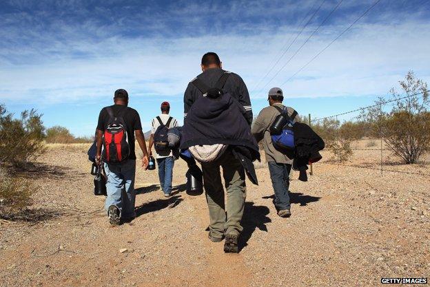 Undocumented Mexican immigrants walk through the Sonoran Desert after illegally crossing the US-Mexico border in 2011