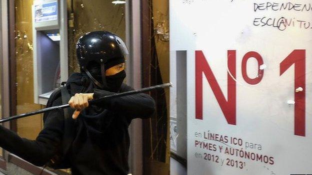 A protestor attacks a bank in last month's demonstrations