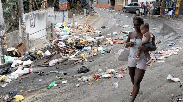 A local walks in the street of the Cantagalo favela in Rio de Janeiro on 23 April 2014