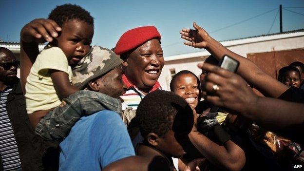 South African political party Economic Freedom Fighters leader Julius Malema (C) greets supporters in Ngcingwane in the Eastern Cape province of South Africa, on 11 April 11 2014