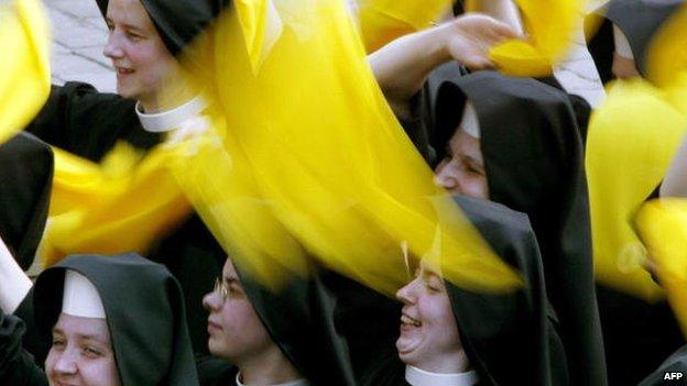 File photo: Nuns wave yellow scarves at the end of a canonisation ceremony held by Pope John Paul II in St Peter's Square, Vatican, 18 May 2003