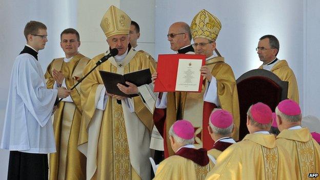 File photo: Archbishop Angelo Amato, the Vatican's Prefect of the Congregation for the Causes of Saints, shows beatification documents in Warsaw on 6 June 2010