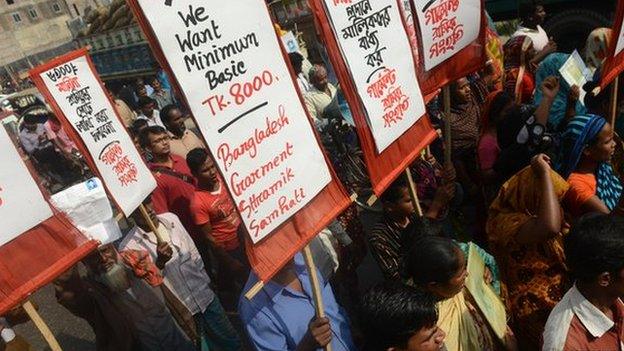 Survivors and relatives of Bangladeshi garment workers killed in the Tazreen Fashions fire accident and Rana Plaza garment factory building collapse gather during a demonstration in Savar, on the outskirts of Dhaka on November 24, 2013