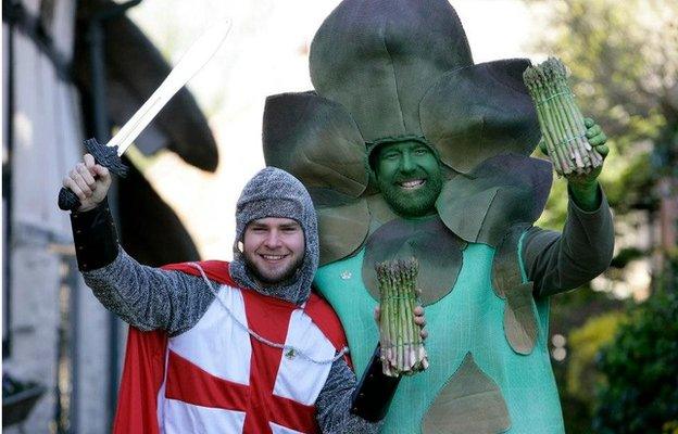 Man dressed as an asparagus and another one dressed as St George