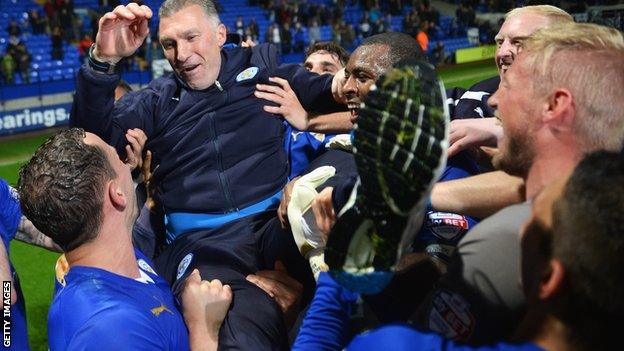 Nigel Pearson celebrates Championship title win with Leicester players.