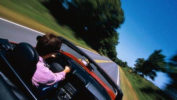 Man at wheel of fast car