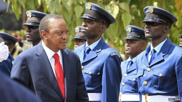 Kenyan President Uhuru Kenyatta inspects a guard of honour as he arrives at parliament in Nairobi - March 2014