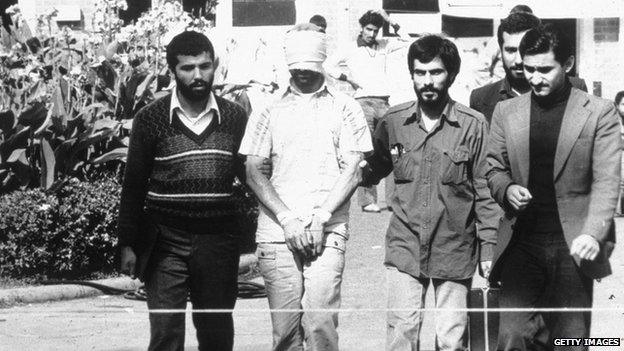 An American hostage with Iranian captors in Tehran, Iran, in 1979