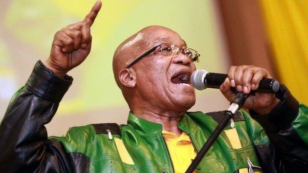 South African President t Jacob Zuma leads hundreds of supporters in singing a song during a campaign event at the Inter-fellowship Church in Wentworth township, outside of Durban, on 9 April 2014