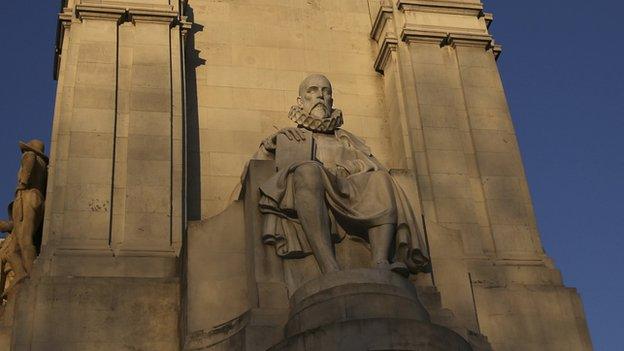 The statue of Miguel de Cervantes, one of Spain's most important literary figures, is seen next to the statue of one of his most famous characters, Don Quixote, from his famous novel at the monument in his honour at Plaza de Espana square in central Madrid March 7, 2014.