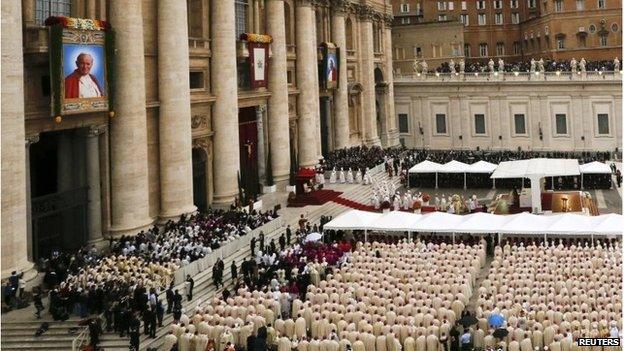 Tapestry portraits of John Paul II (L) and Pope John XXIII and are seen in St Peter's Square at the Vatican April 27