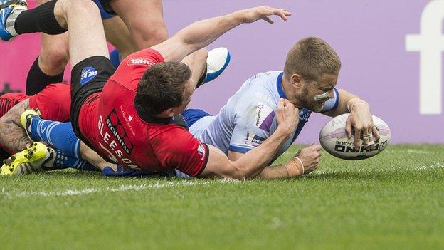 Rhys Hanbury scores one of his two tries at Salford