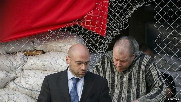 Detained international observer (R) leaves mayor's office in Sloviansk with OSCE official (L) 27/04/2014