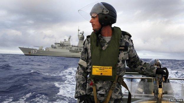 Leading Seaman William Sharkey searches for possible debris in the southern Indian Ocean in the continuing search for the missing Malaysian Airlines flight MH370 in this picture released by the Australian Defence Force on 17 April, 2014