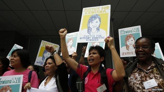 Protesters from labour organisations hold drawings of Indonesian domestic helper Erwiana Sulistyaningsih, who underwent suspected abuse by her Hong Kong employer, during a rally while delivering an international petition to the Hong Kong government, in Hong Kong 27 April 2014