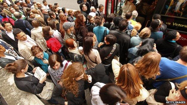 Commuters queue for buses outside Victoria Station during the last strike