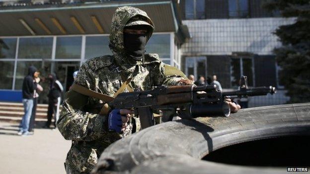 A pro-Russian armed man holds his weapon in front of the seized town administration building in Kostyantynivka April 28, 2014