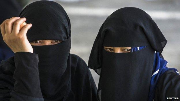 Suspected Uighurs from China's troubled far-western region of Xinjiang, look on inside a temporary shelter after they were detained at the immigration regional headquarters near the Thailand-Malaysia border in Hat Yai, Songkla, 14 March 2014