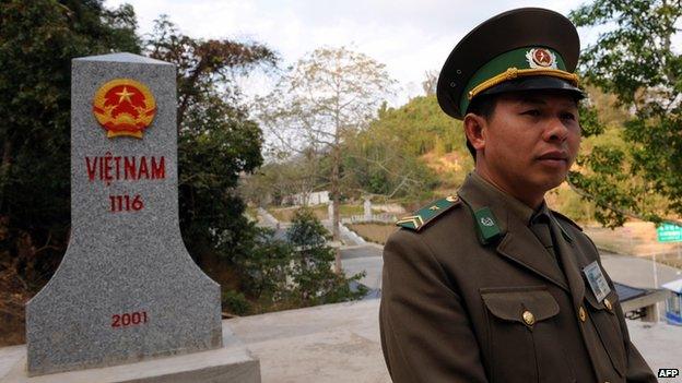 File photo: A Vietnamese border guard walks next to a border marker placed in the Vietnamese side at the Friendship border Gate in the northern border province of Lang Son