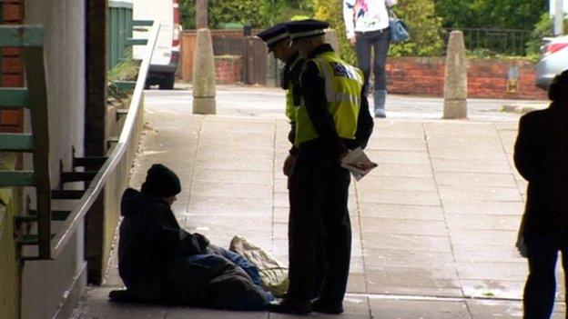 Police talking to a beggar