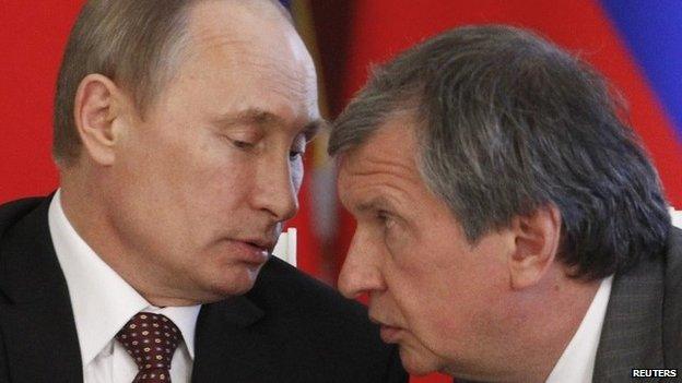 Russian President Vladimir Putin talks to Rosneft chairman Igor Sechin at the Kremlin (2 July 2013)