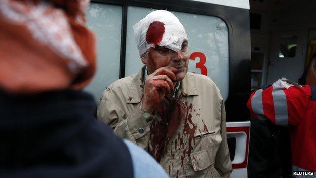 An injured man is treated in Donetsk. Photo: 28 April 2014