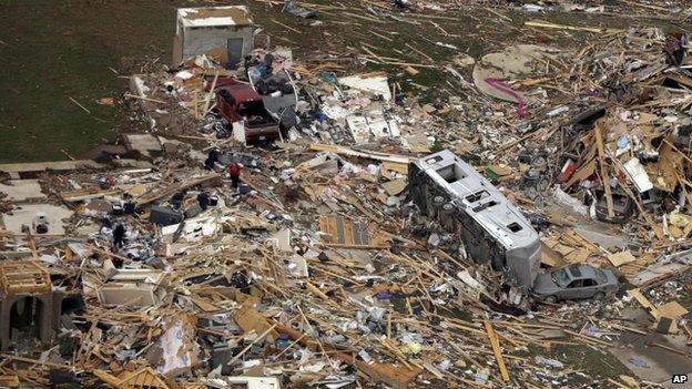 A travel trailer sits in the rubble of a house in Mayflower, Arkansas, 28 April 2014