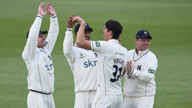 Warwickshire players celebrate Chris Wright's one of match hau