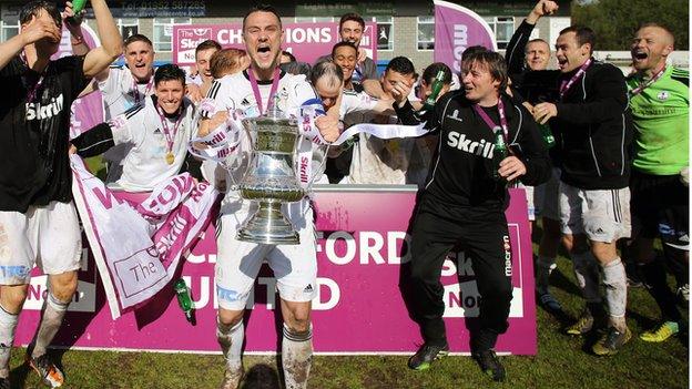 Ryan Young helps AFC Telford United celebrate their Conference North title triumph at the Bucks Head