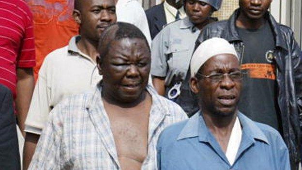 Morgan Tsvangirai (l) leaves the court in Harare on 13 March 2007, after he was arrested and beaten