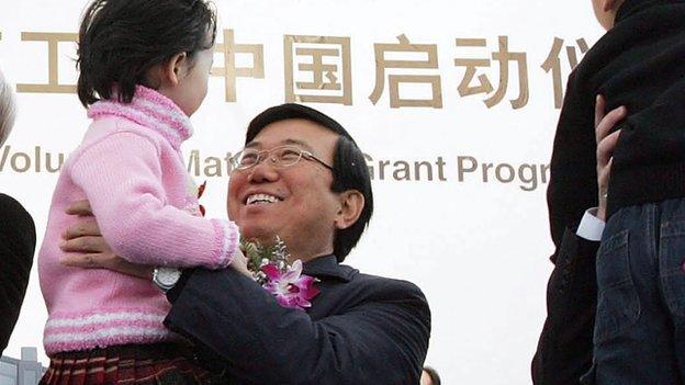 Li Chuncheng, secretary of the CPC Chengdu City Committee holds a child during the opening ceremony for the Intel Chengdu Assembly and Testing Plant, at Chengdu West Industrial Development Zone on 6 December, 2005 in Chengdu of Sichuan Province, China