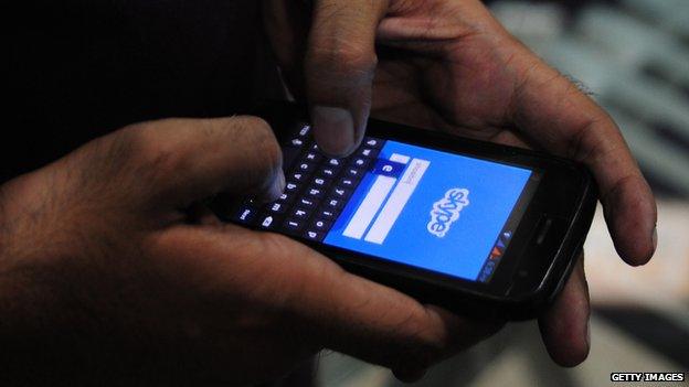 Man accessing Skype on his phone