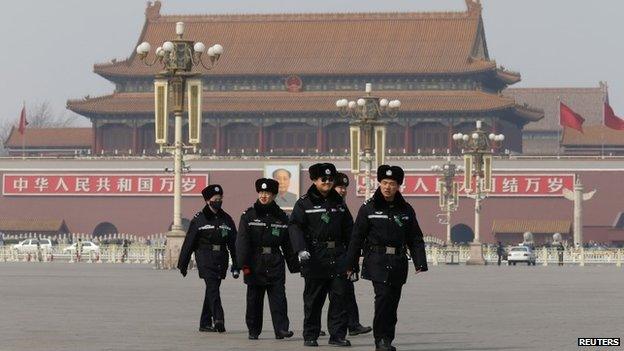 Policemen patrol in front of the Tiananmen Gate and the giant portrait of China"s late chairman Mao Zedong, at the Tiananmen Square near the Great Hall of the People after a plenary session of the NPC, in Beijing