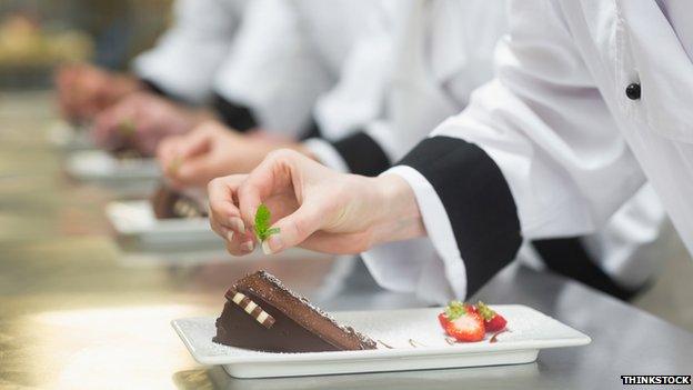 Workers garnish cakes