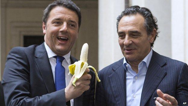 Italian premier Matteo Renzi, left, and Italian national football team coach Cesare Prandelli share a banana in solidarity with Barcelona Brazilian player Dani Alves, in Rome, on 28 April