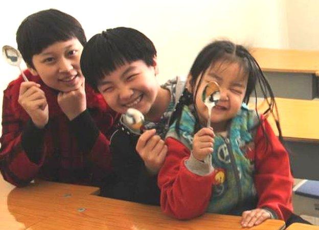 Children waving spoons