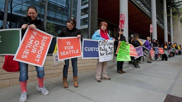 Supporters of a measure to raise the minimum wage to $15 an hour surround City Hall for about 40 minutes Seattle, Washington 23 April 2014