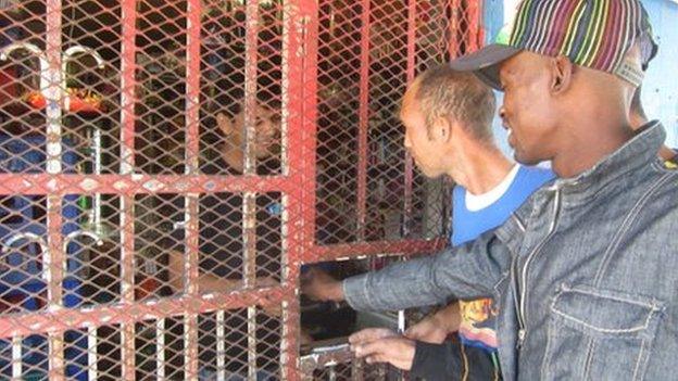 Customers at one of South Africa's spaza small shops