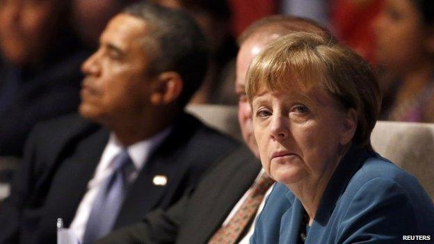 US President Barack Obama, Germany's Chancellor Angela Merkel (L-R) attend the opening session of the Nuclear Security Summit in The Hague 24 March 2014