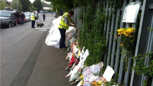 Council worker covering up flowers with tarpaulin