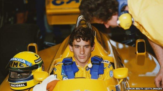 Ayrton Senna sitting into his Team Lotus car