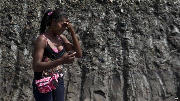 Woman cries at collapsed mine in Colombia